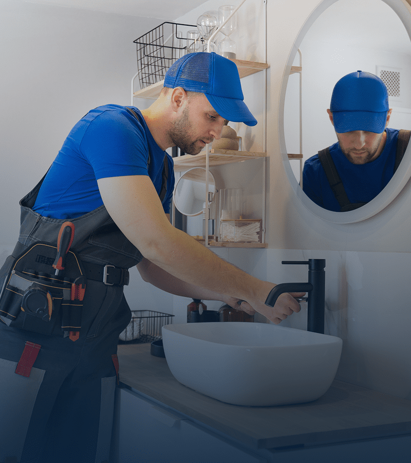 Handyman adjusting faucet in bathroom