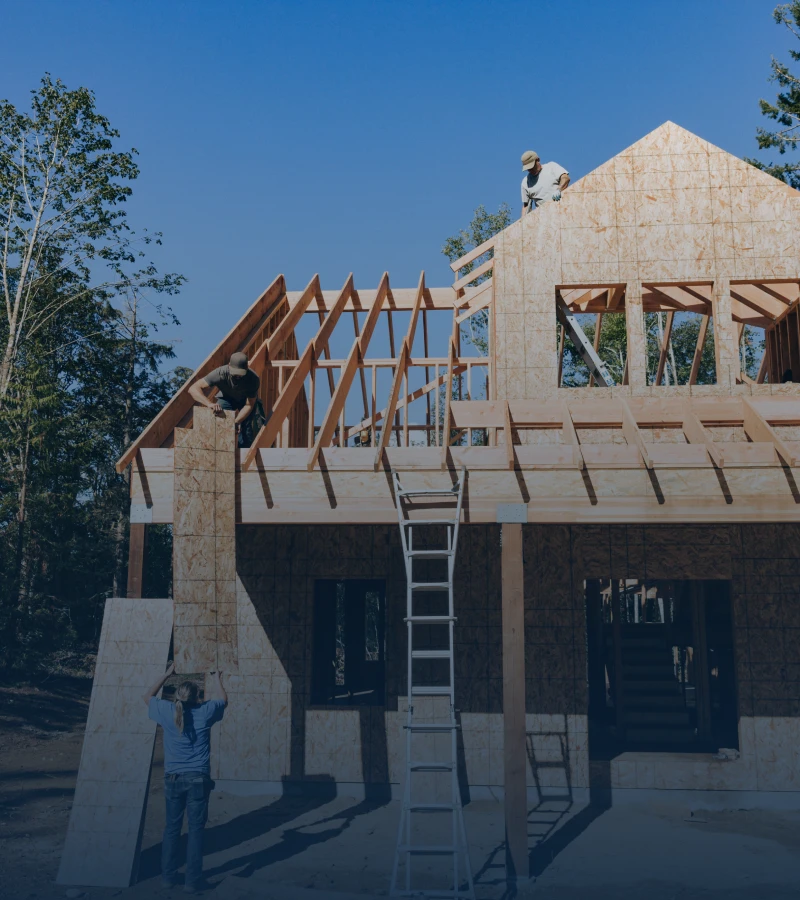 House under construction with workers