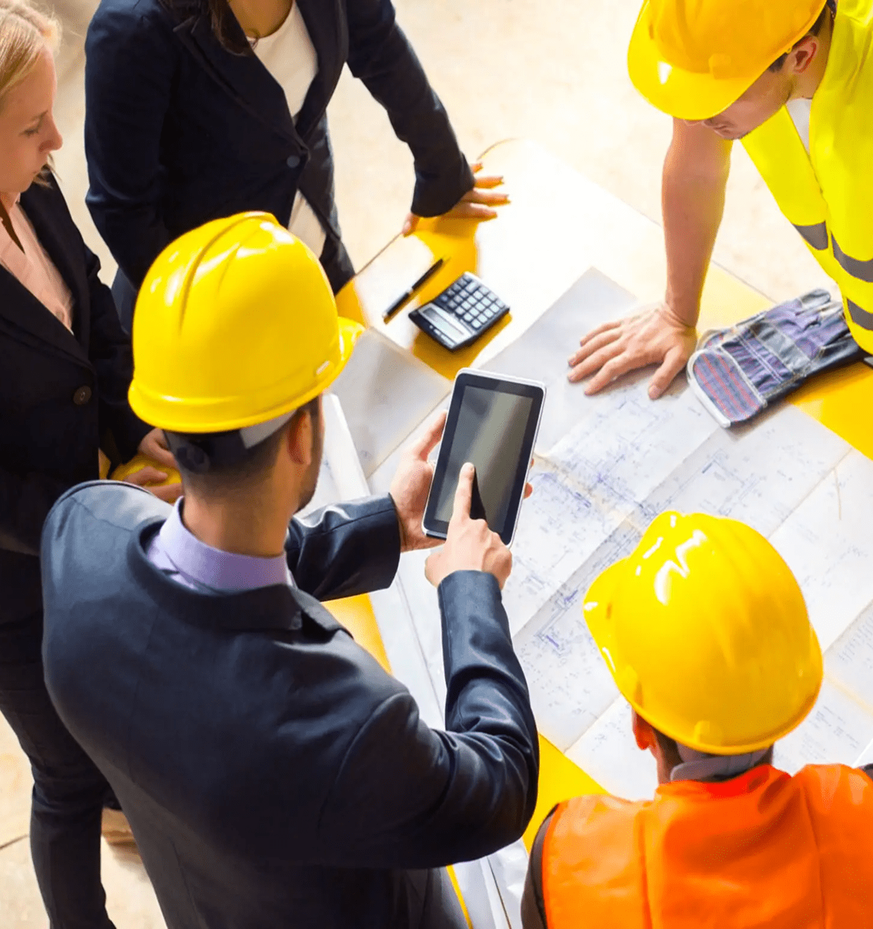 Workers in hard hats examining site layout