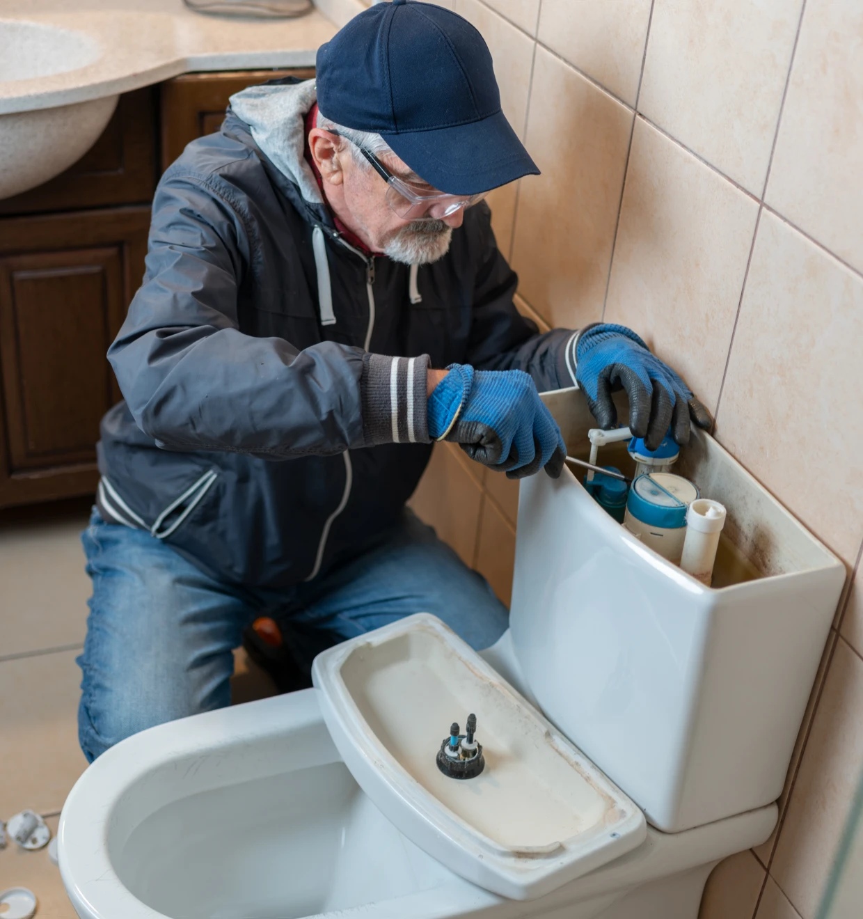 Plumber fixing toilet tank
